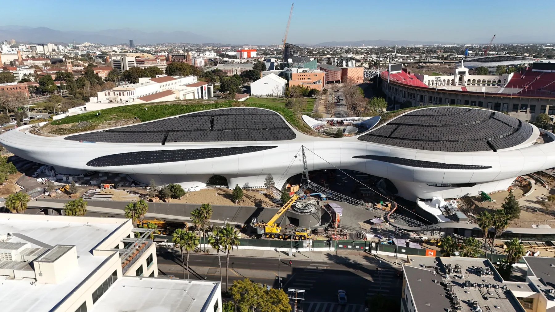 Aerial view of the Lucas Museum of Narrative Art and its sweeping curved roof in Exposition Park