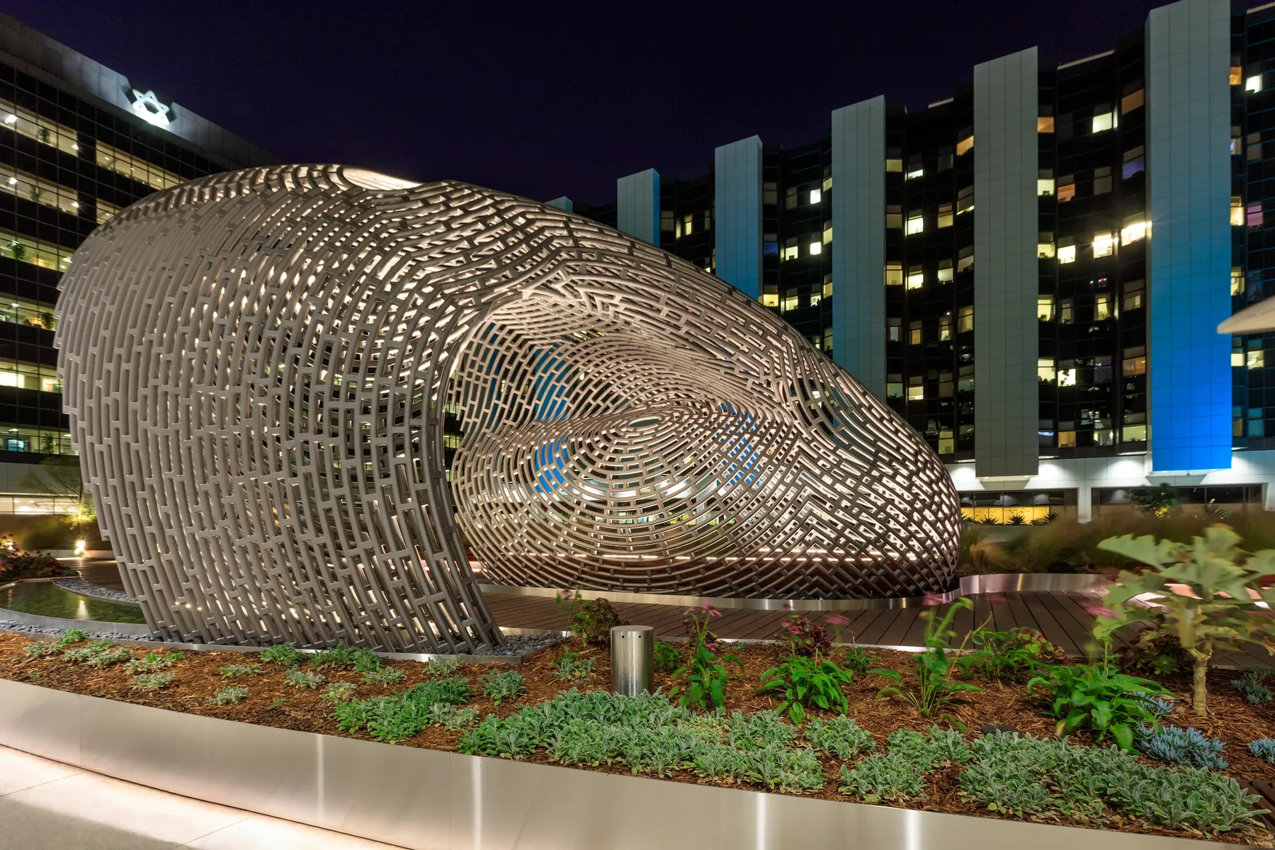 Illuminated woven metal sculpture in the landscaped Healing Garden at Cedars-Sinai Medical Center